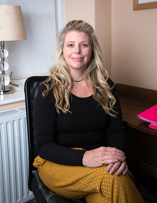 Atlanta Rayner, multi-dimensional psychotherapist and clinical supervisor, seated and smiling
